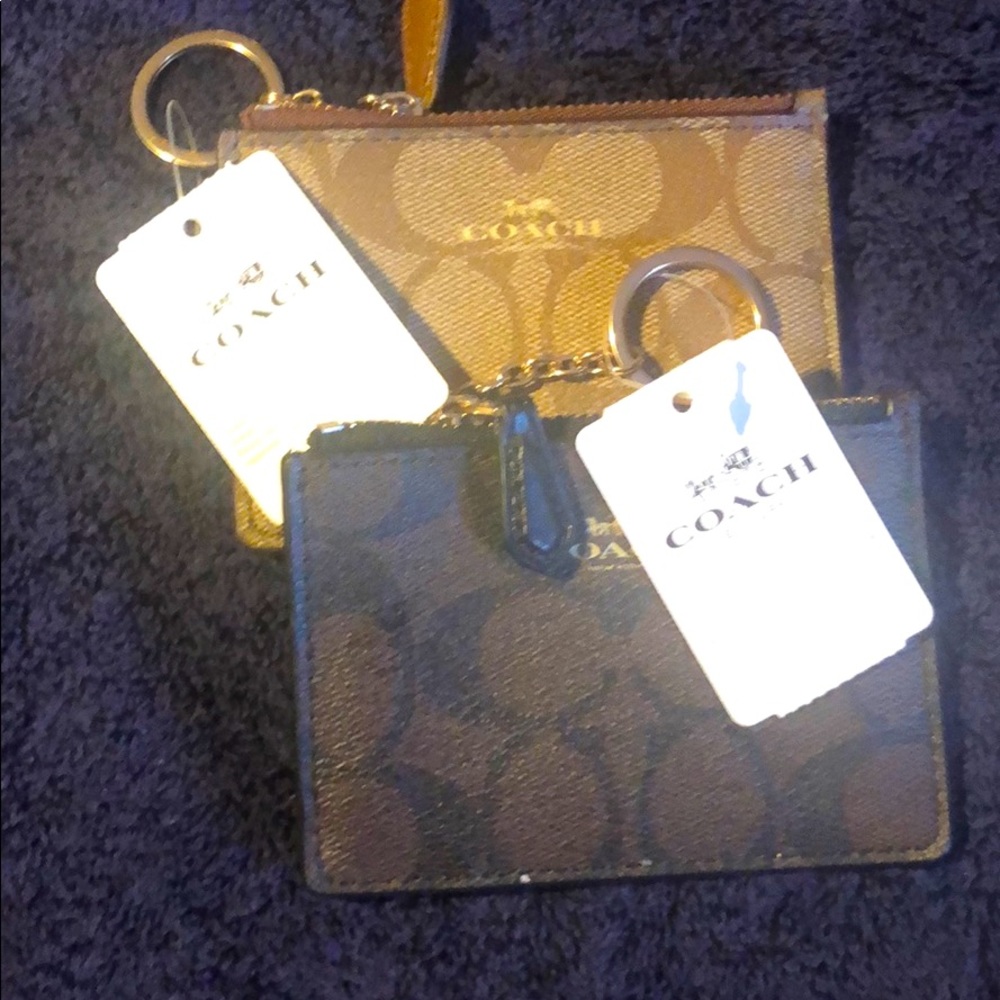 Two Coach keychain ID wallets.
